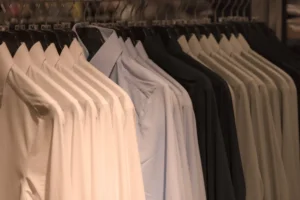 various shirts hanging on hangers