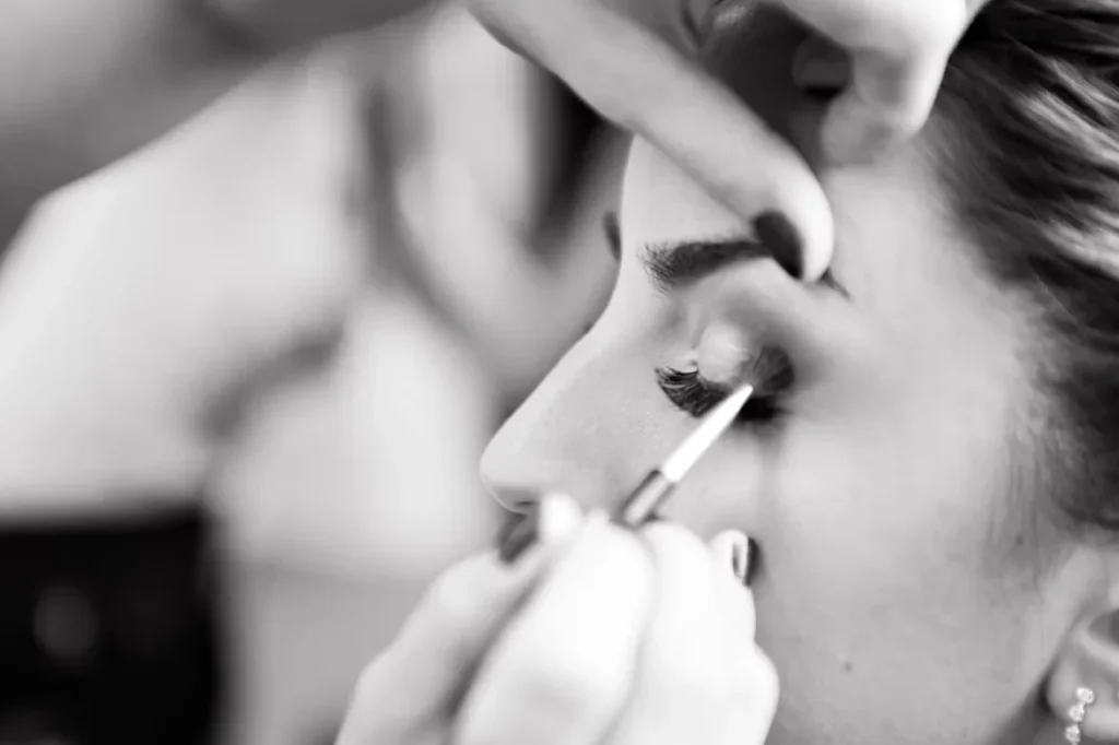 woman applying makeup on her face