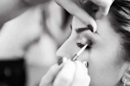 woman applying makeup on her face