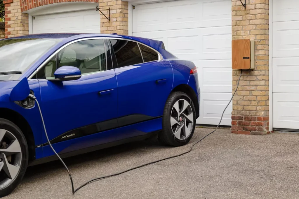 A Beginner’s Guide to Installing EV Car Chargers a blue car plugged in garage