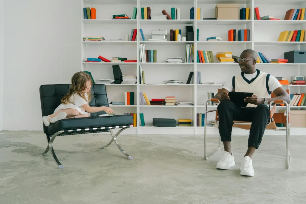 a man and a little girl sitting on chairs