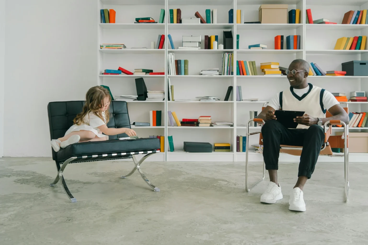 a man and a little girl sitting on chairs