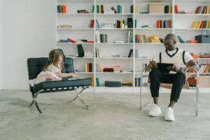 a man and a little girl sitting on chairs