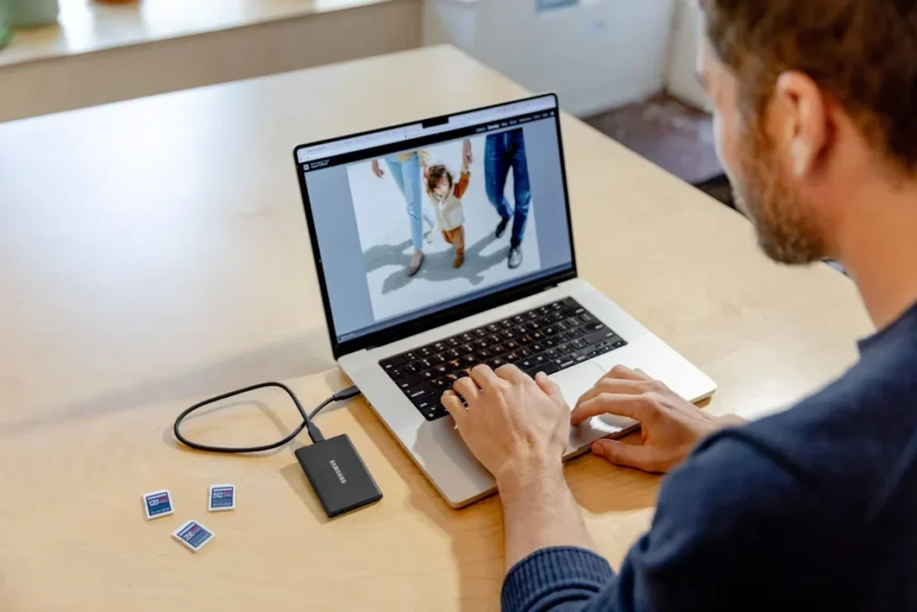 Top Reasons to Choose Reliable Micro SD Cards a man sitting on table using laptop