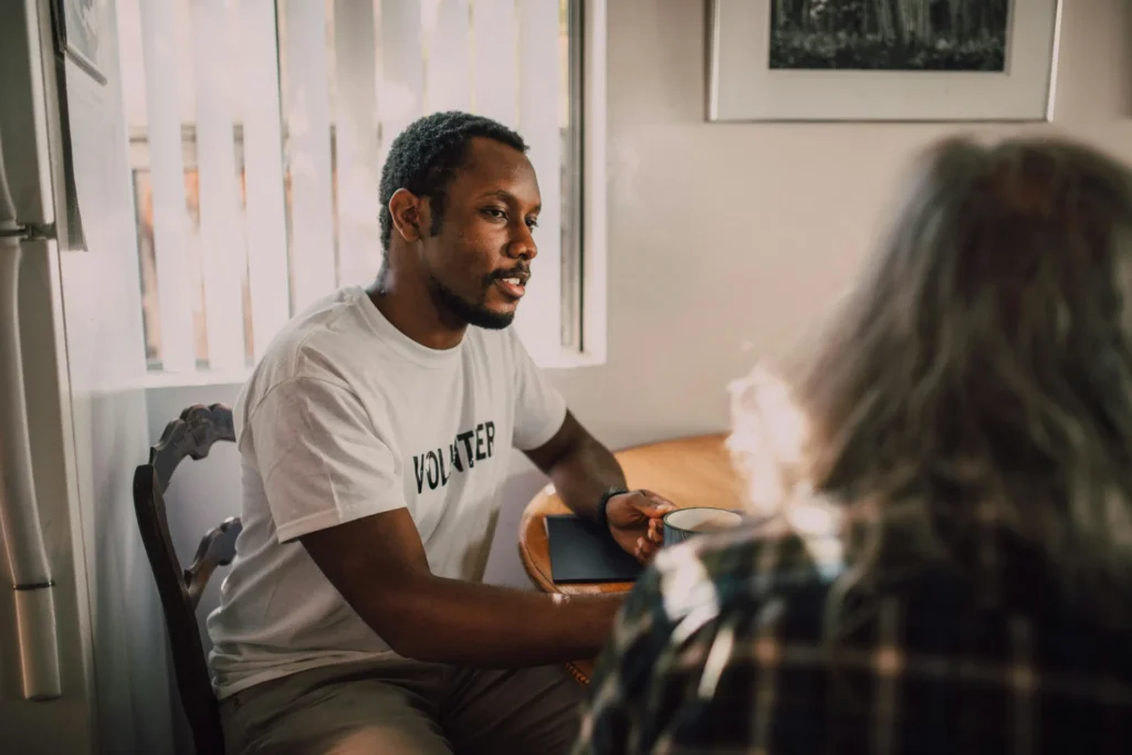 a man wearing white shirt sitting on chair