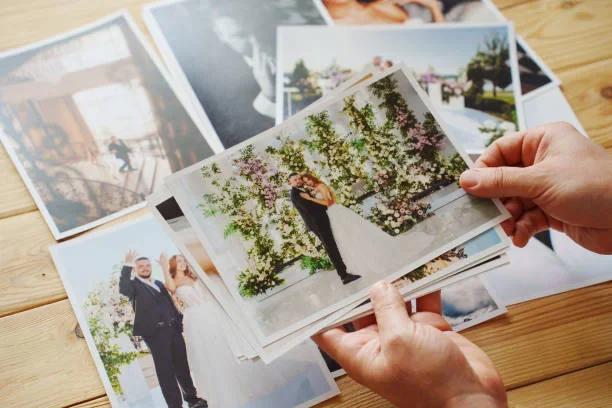 a person holding wedding photographs