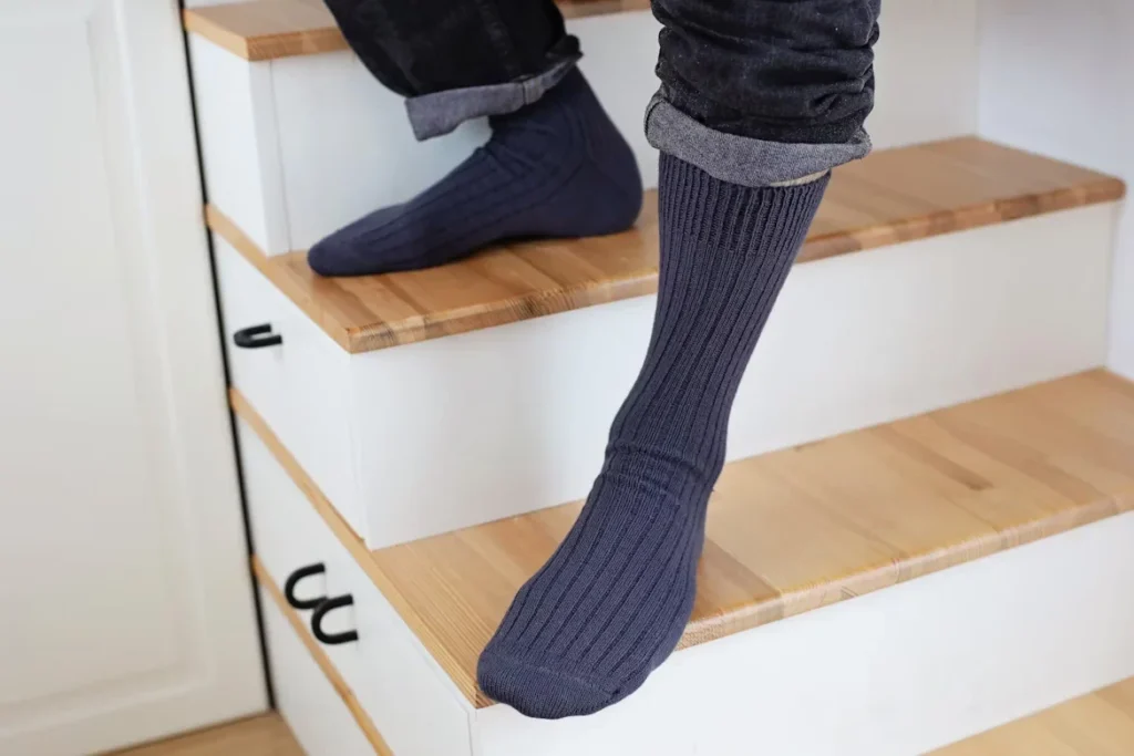 Why Crew Socks Are a Wardrobe Essential for All a person standing on stairs