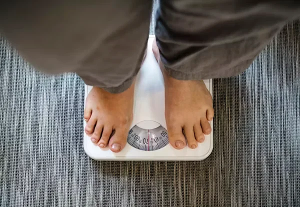 What to Know About Berberine and Its Use in UK Health Trends a person standing on weighing machine