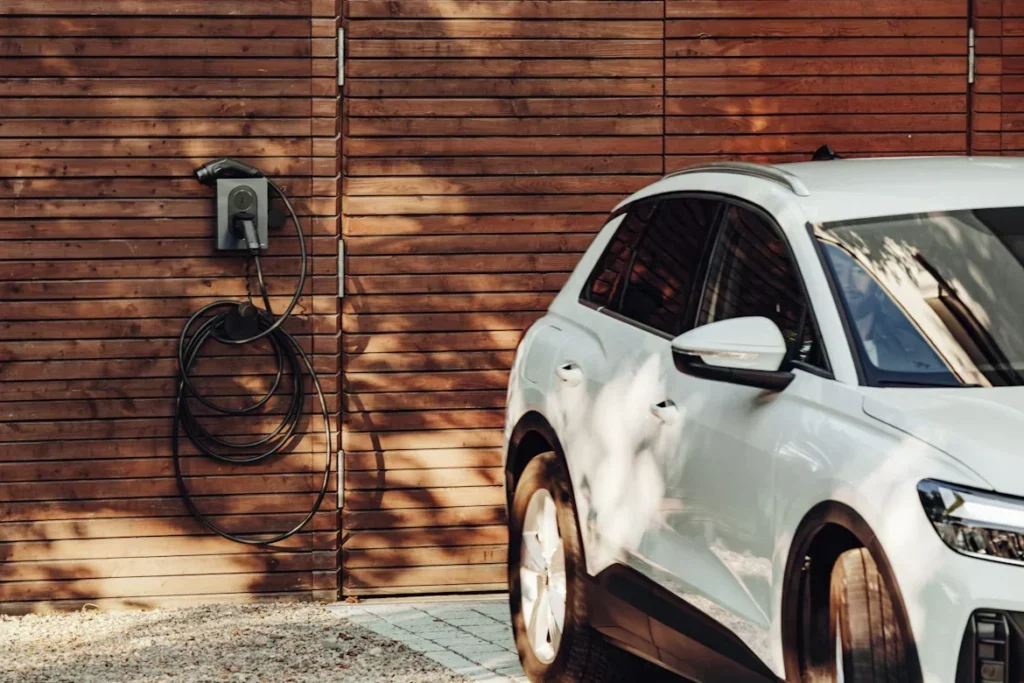 A Beginner’s Guide to Installing EV Car Chargers a white car parked in front of wooden wall