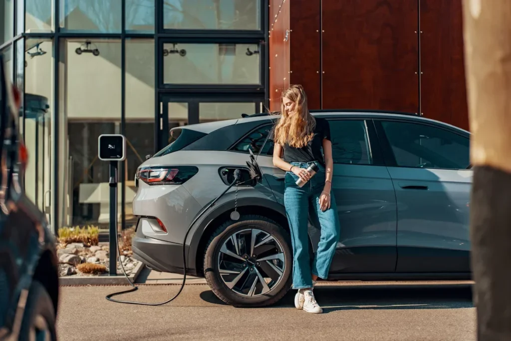 a woman standing next to a car