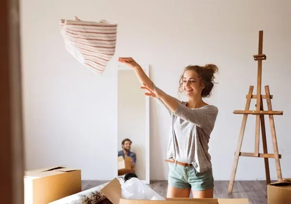 Settling Into Your Dream Home: A Complete Guide for New Owners a woman throwing balnket