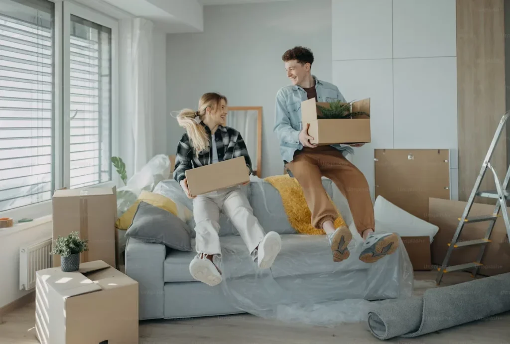 Settling Into Your Dream Home: A Complete Guide for New Owners a young couple sitting on couch