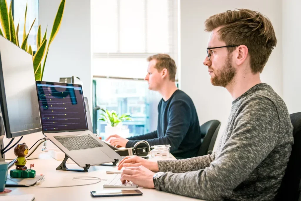 man sitting on chair working on laptop