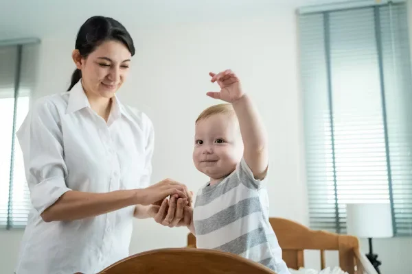 woman holding baby's hand