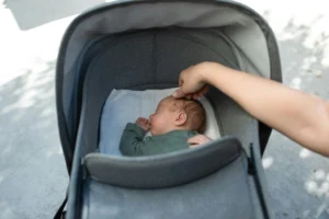 a baby sleeping in stoler