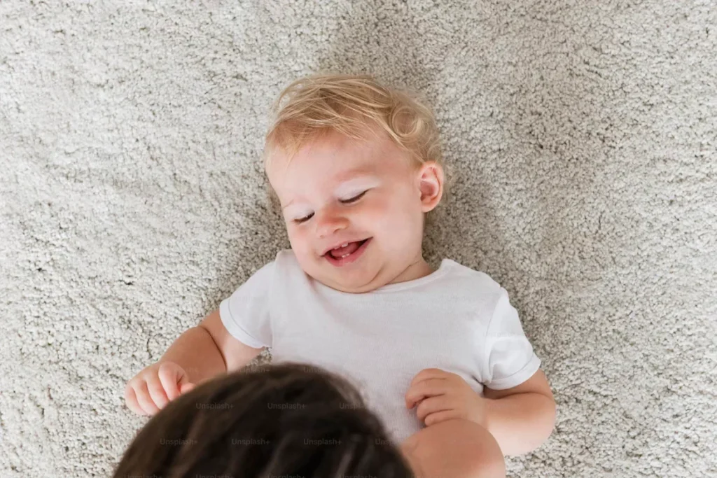 cheerful baby lying on floor