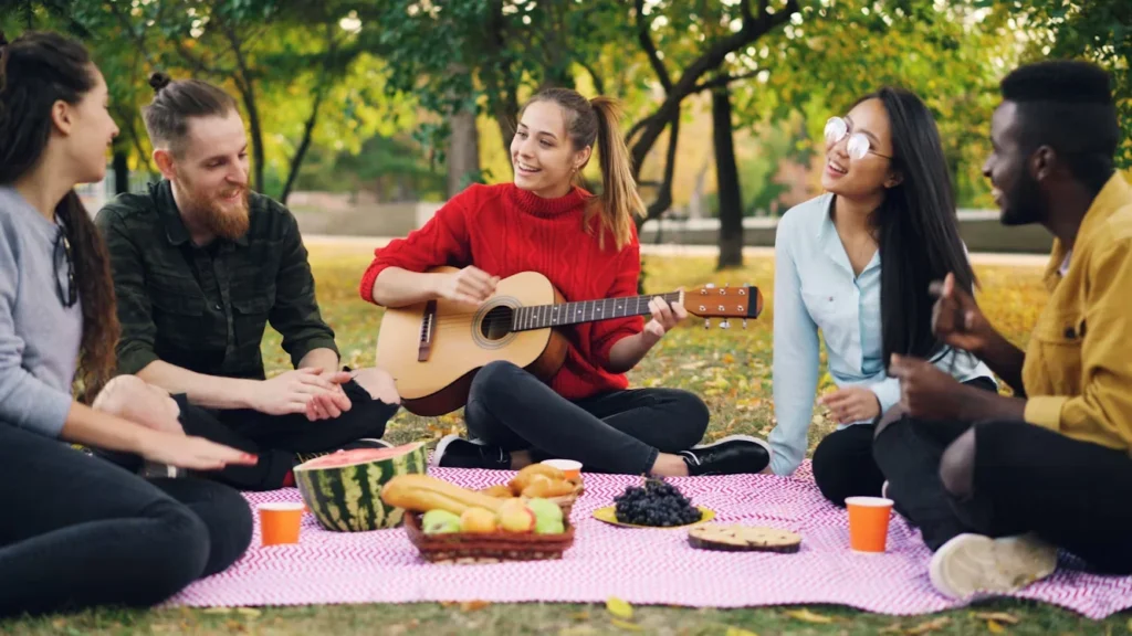friends enjoying a picnic and playing music