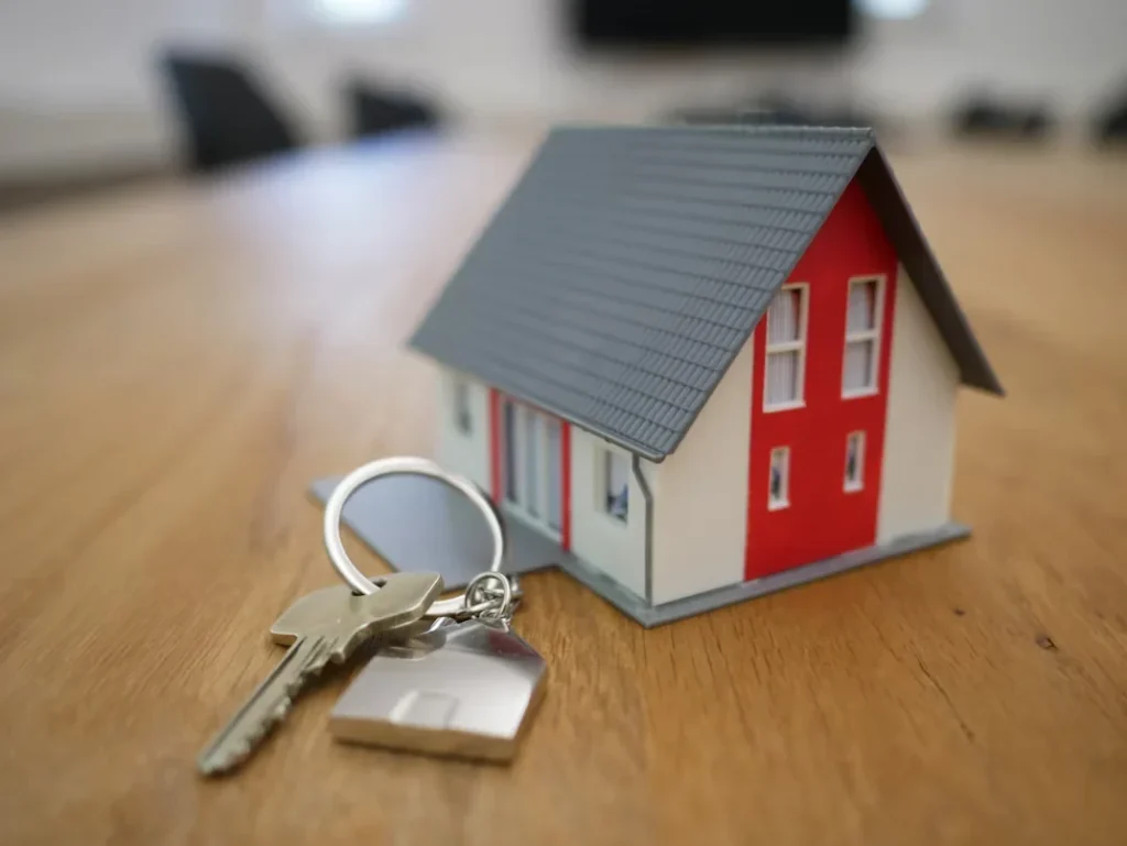 white and red wooden house with key