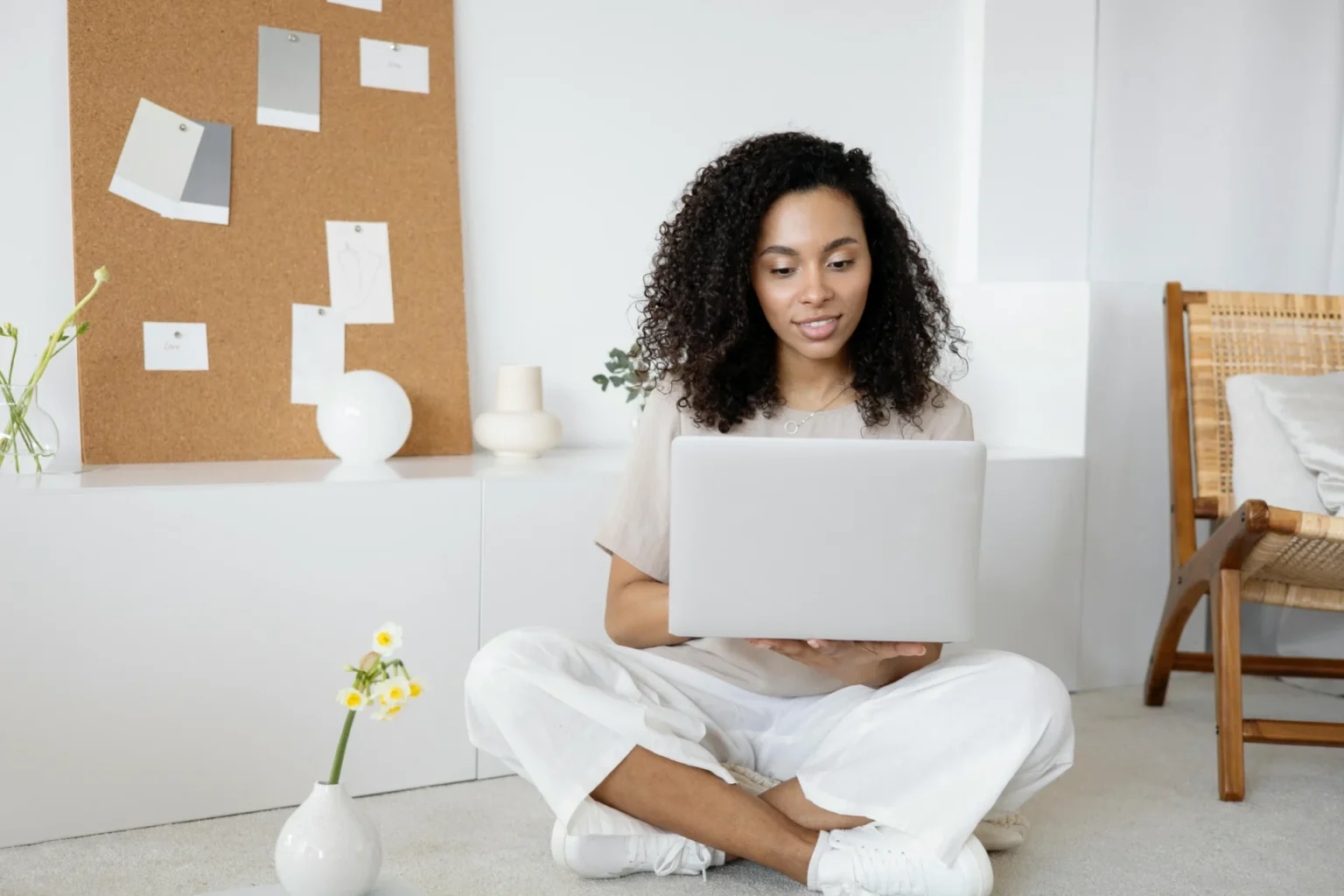 woman sitting on floor using laptop