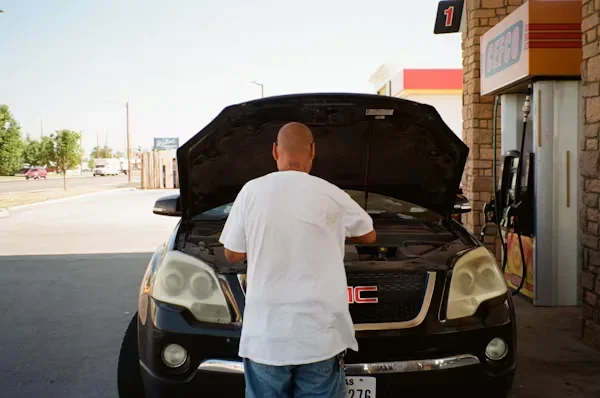 a man checking his car engine