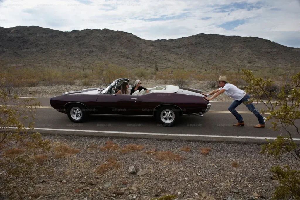 a man pushing teh car.
