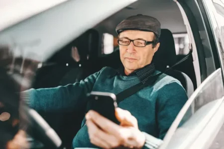 a man using mobile phone while driving