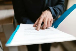 a person pointing at a paper e1759412209784
