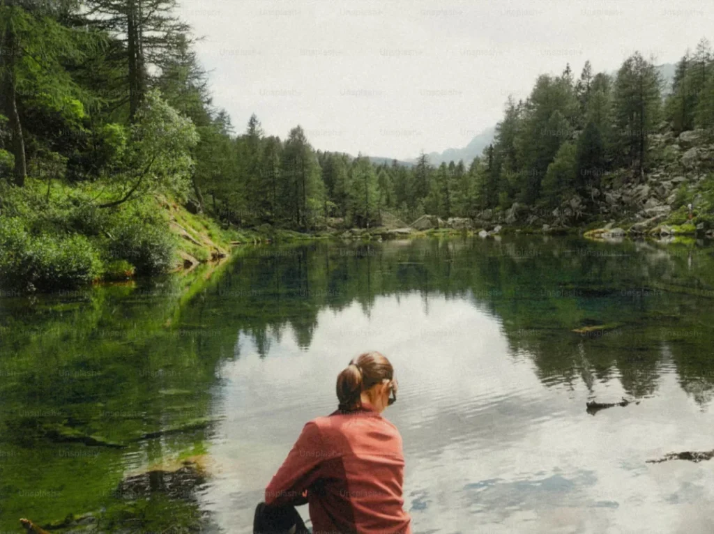 woman sitting by the lake