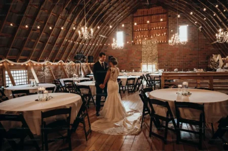 a bride and groom in a barn