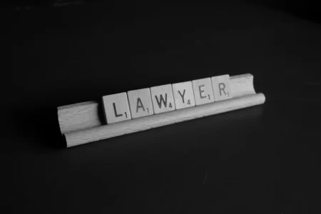 How a Car Accident Attorney Can Maximize Your Injury Claim brown wooden scrable on black table