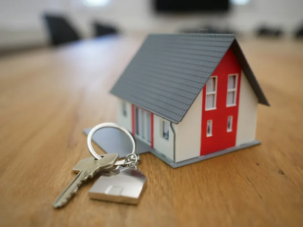 a wooden house and key on table