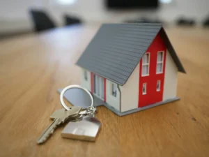a wooden house and key on table