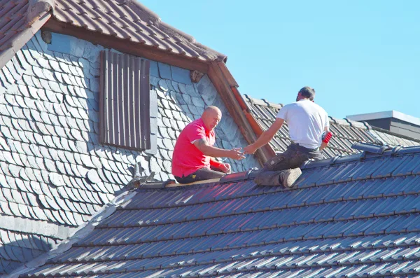 two men repairing roof
