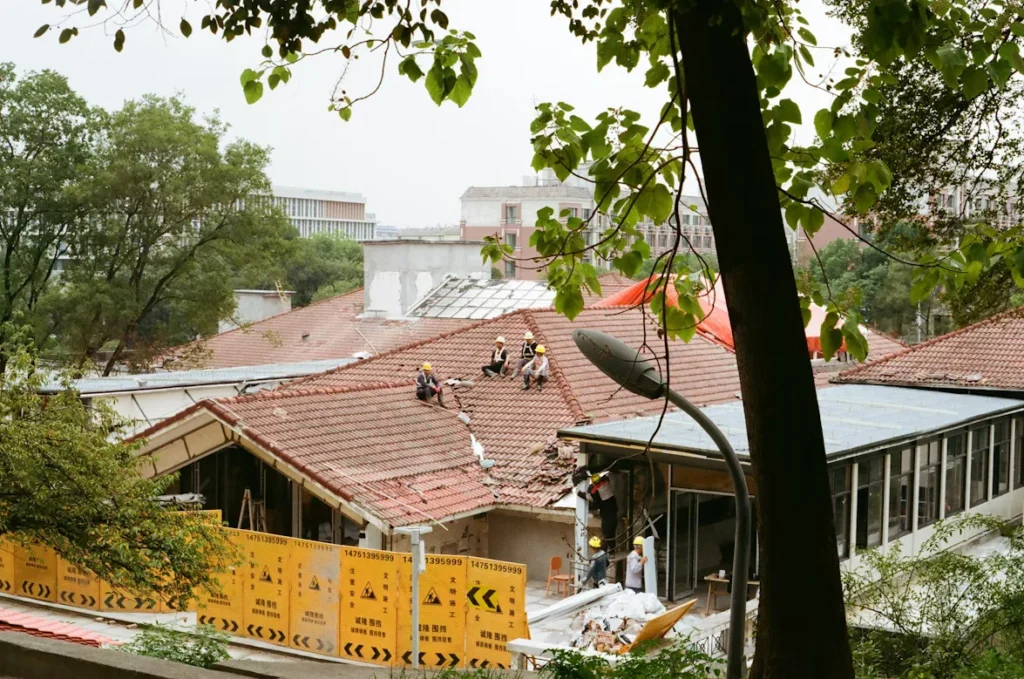 What Roofing Services Typically Include For Properties workers repairing damaged roof