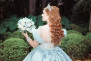 Magical outfits and dresses are an opportunity to create a dreamy fairytale look. a girl wearing blue dress holding flowers