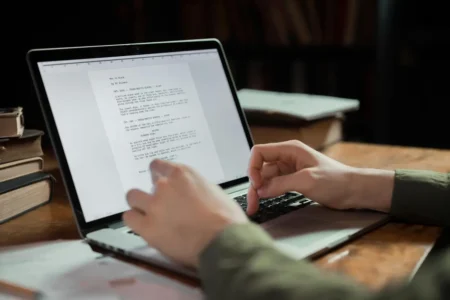 person typing on laptop