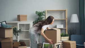 a woman picking up a box